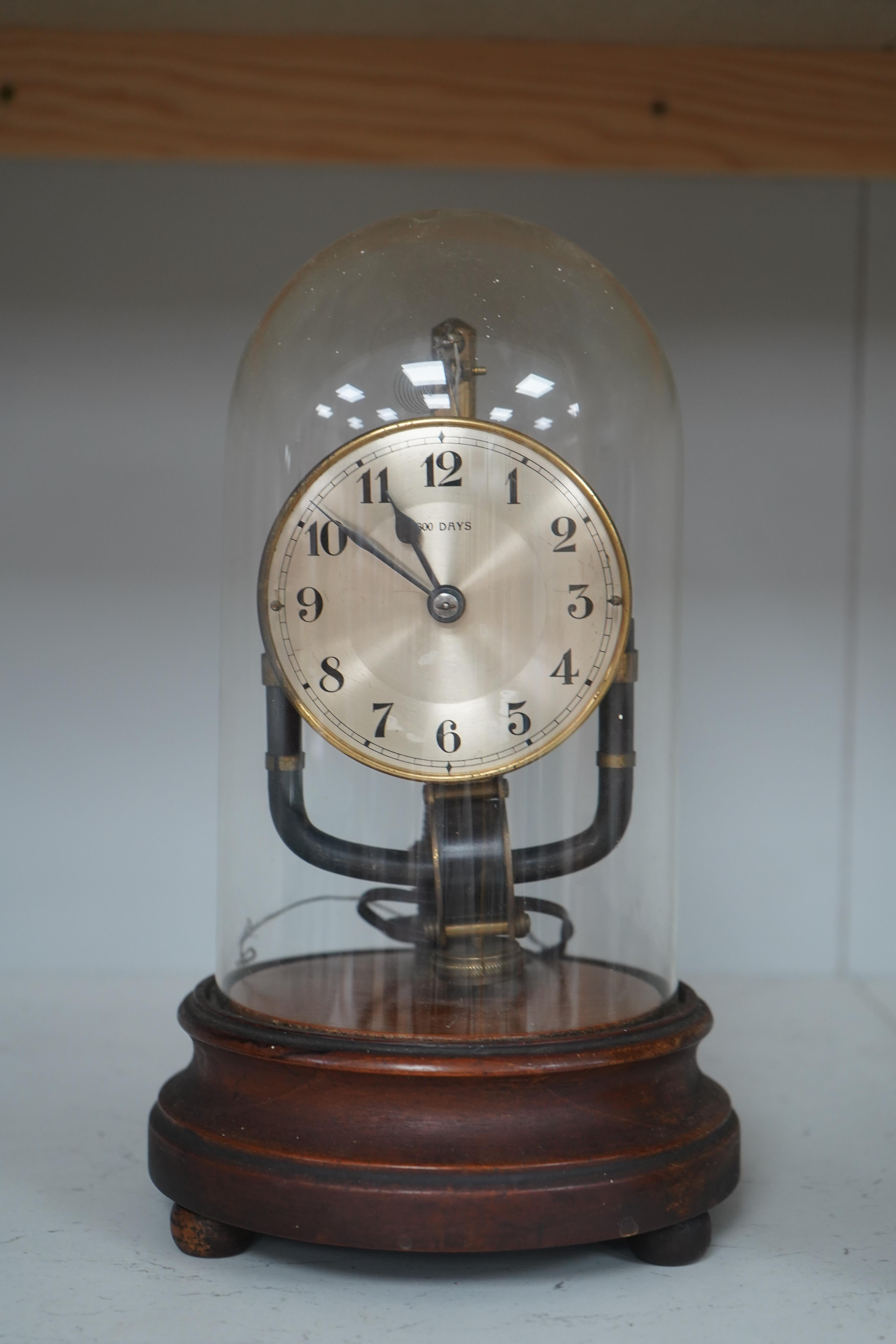 A Bulle type 800 day electric clock, under a glass dome, 26cm high. Condition - fair, untested